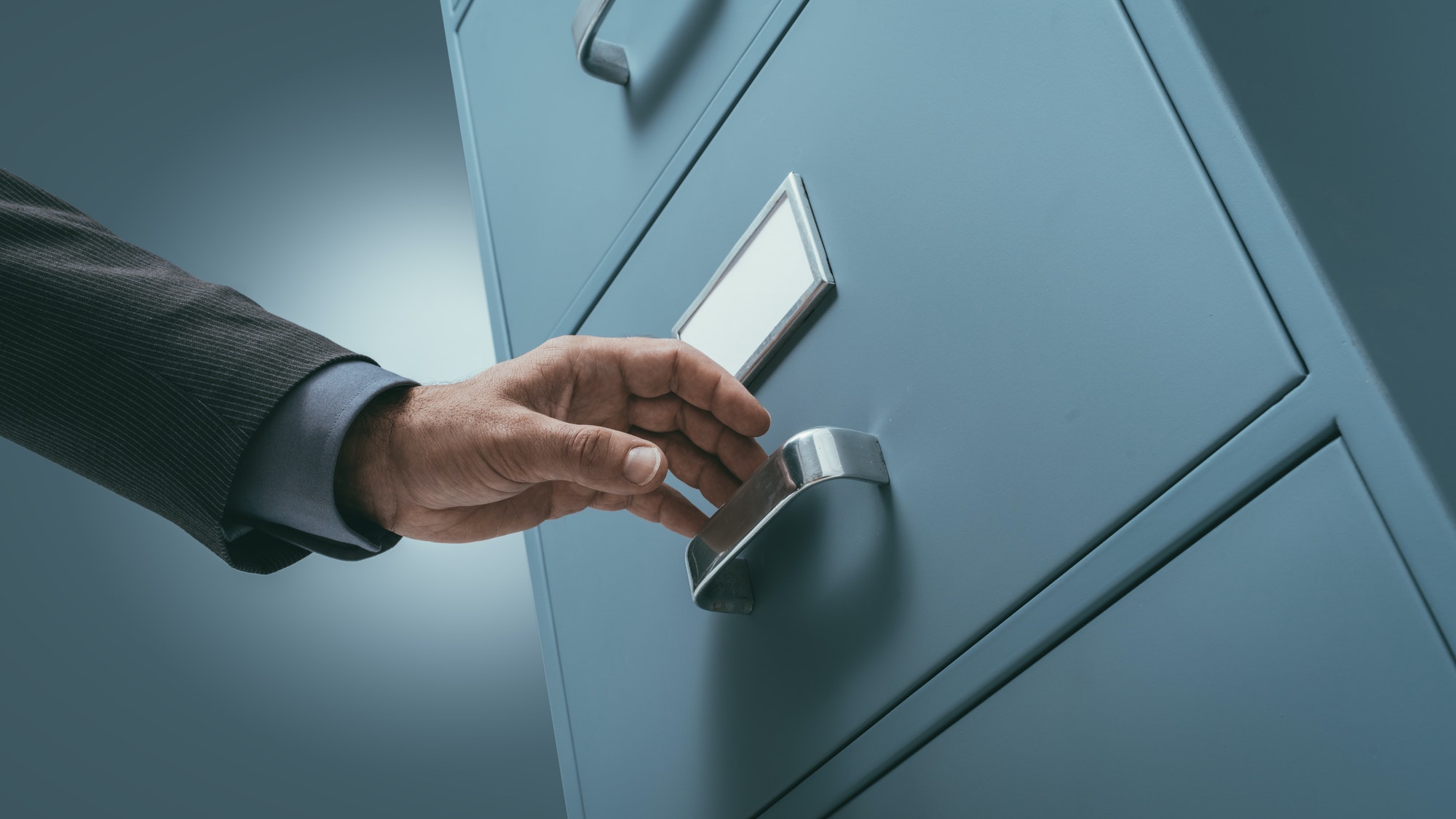 Office clerk searching files in the filing cabinet